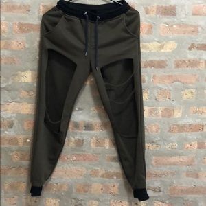 Olive green ripped sweatpants/joggers.